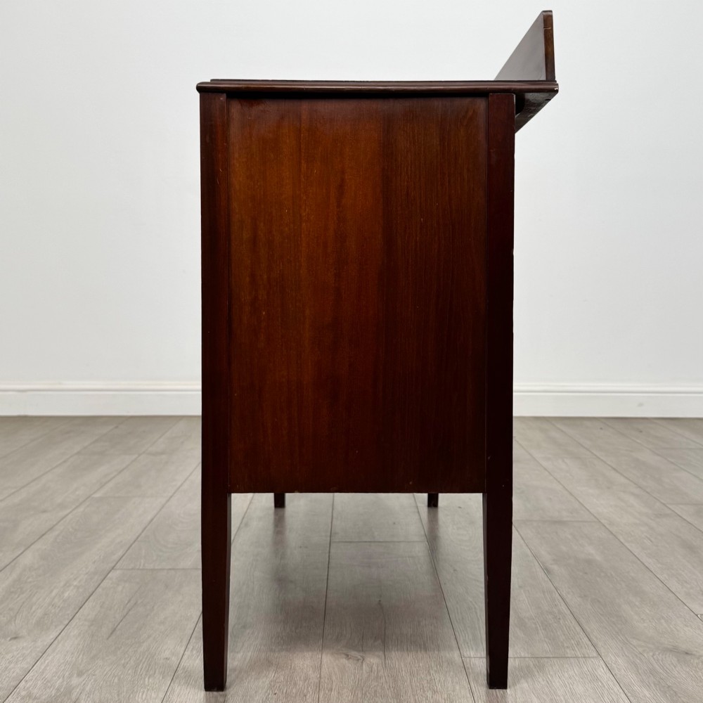 A 20th-century mahogany chest of drawers featuring three straight drawers with string inlay borders, brass ring handles, and square tapered legs. View III