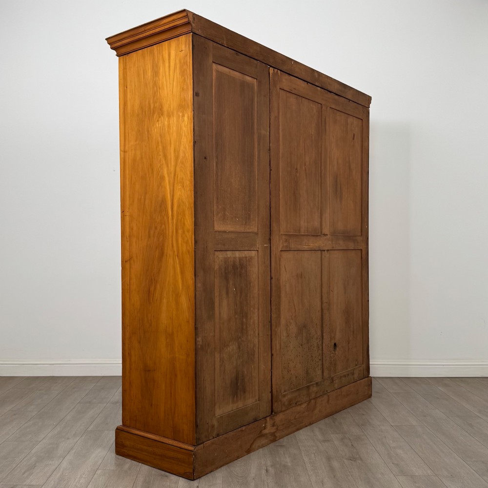 A large Art Deco burr walnut triple wardrobe featuring a central mirror door flanked by two panelled doors over base drawers. View V