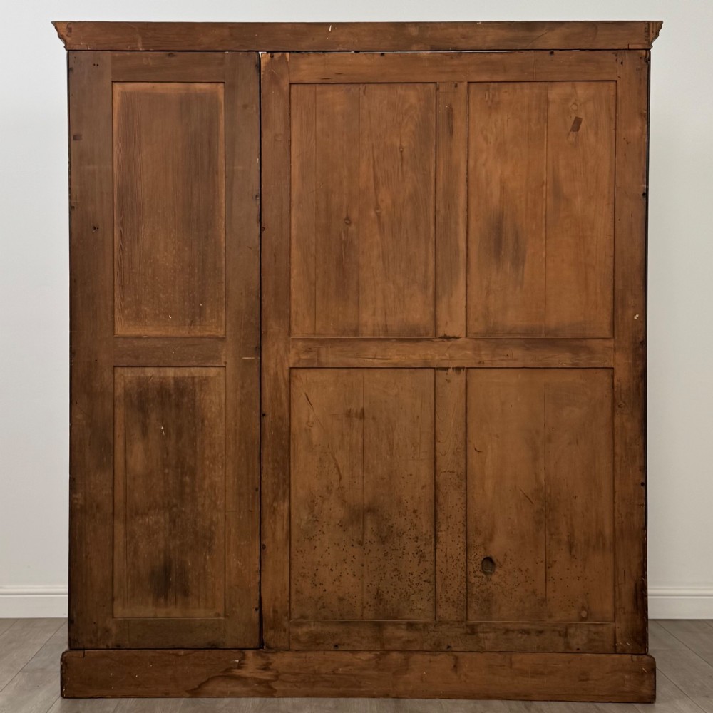 A large Art Deco burr walnut triple wardrobe featuring a central mirror door flanked by two panelled doors over base drawers. View VI