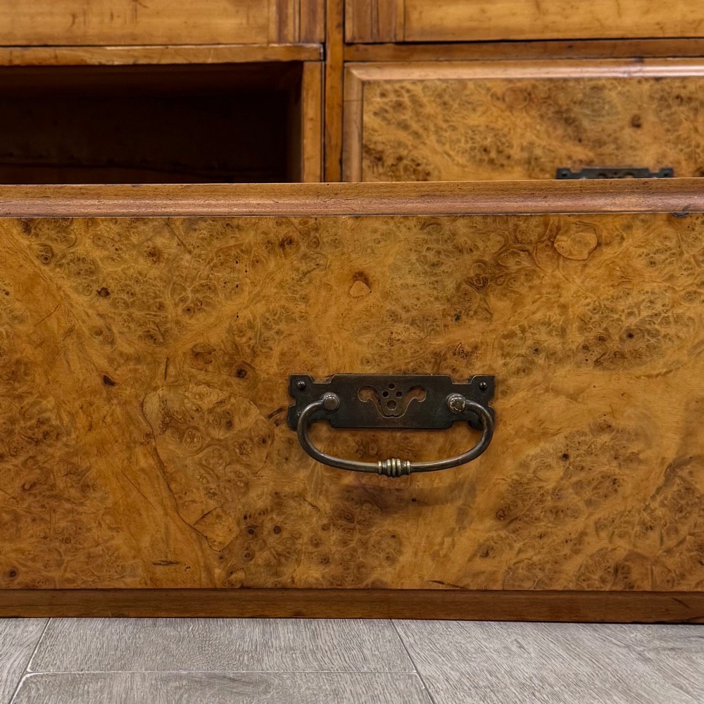 A large Art Deco burr walnut triple wardrobe featuring a central mirror door flanked by two panelled doors over base drawers. View XI