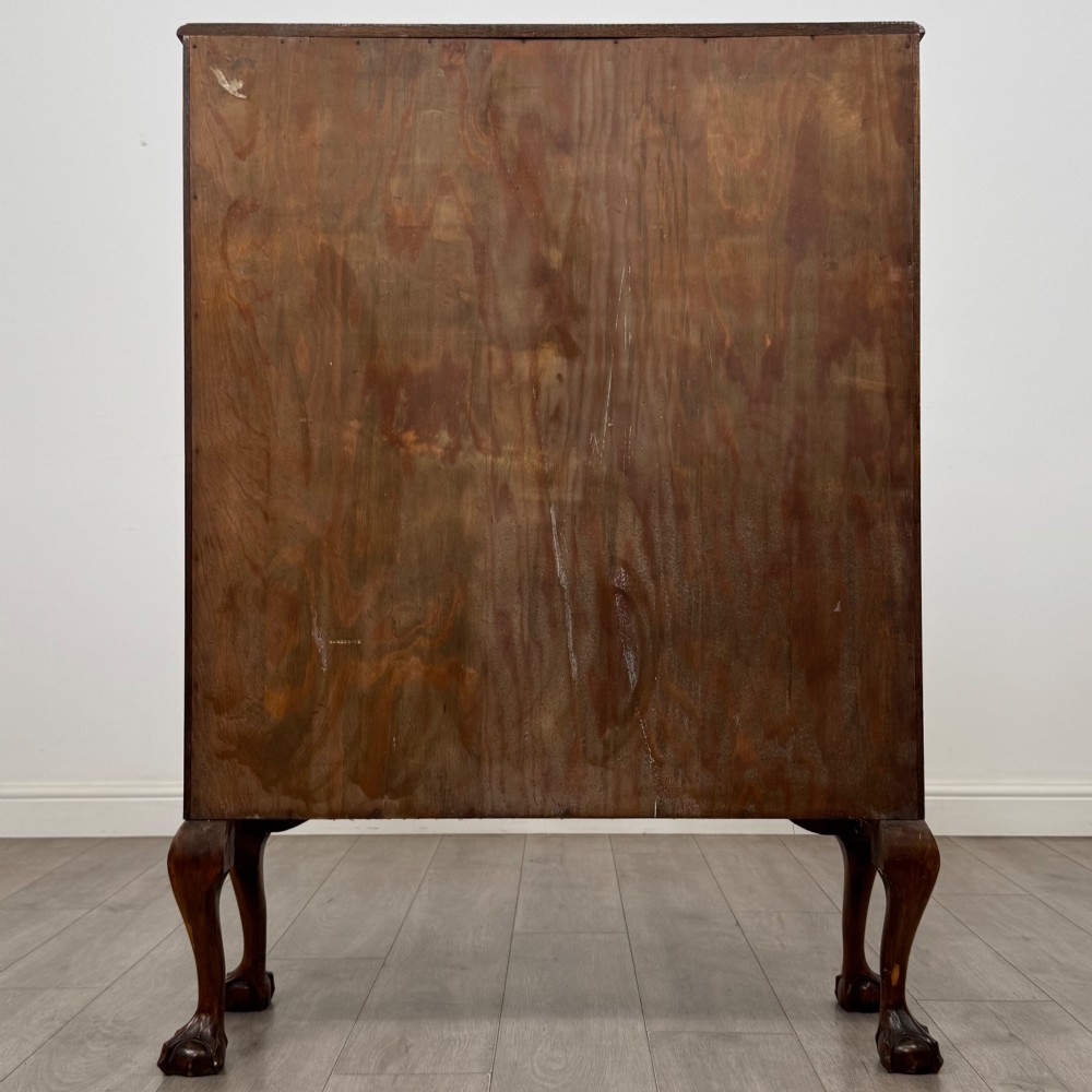 An antique 20th-century oak display cabinet featuring twin glazed doors, glass interior shelves, a carved top frieze, and cabriole legs ending in ball-and-claw feet. View VII