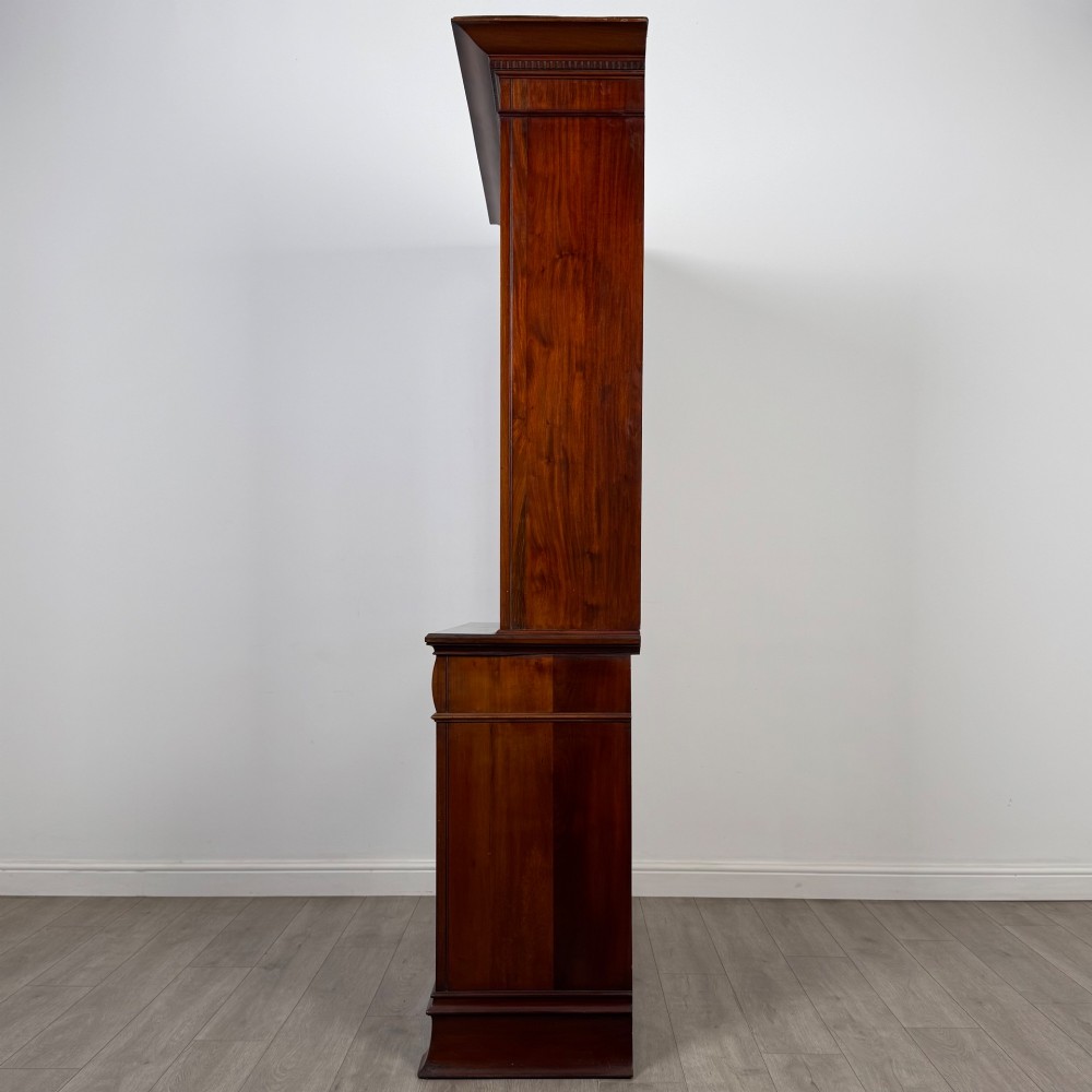 An antique 20th-century mahogany glazed bookcase featuring two upper glass doors, twin middle drawers, and carved lower cupboard doors. View V