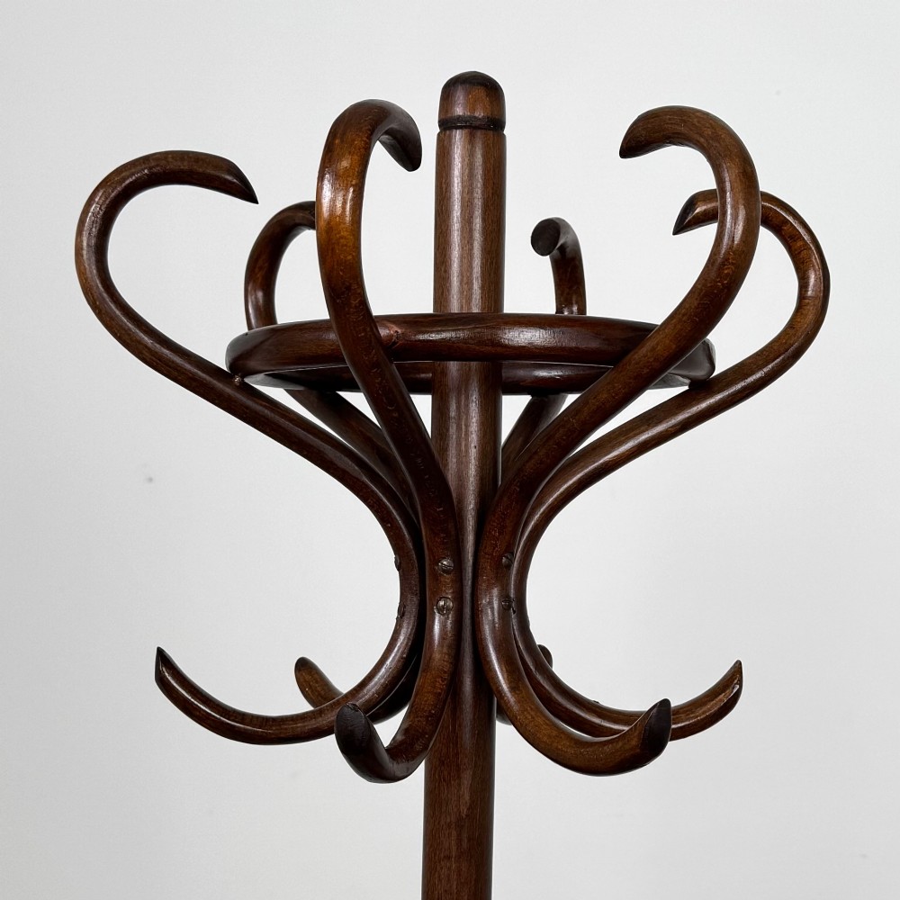 A tall dark brown beech bentwood coat stand featuring multiple curved hooks at the top and a circular quadruped base. View IV