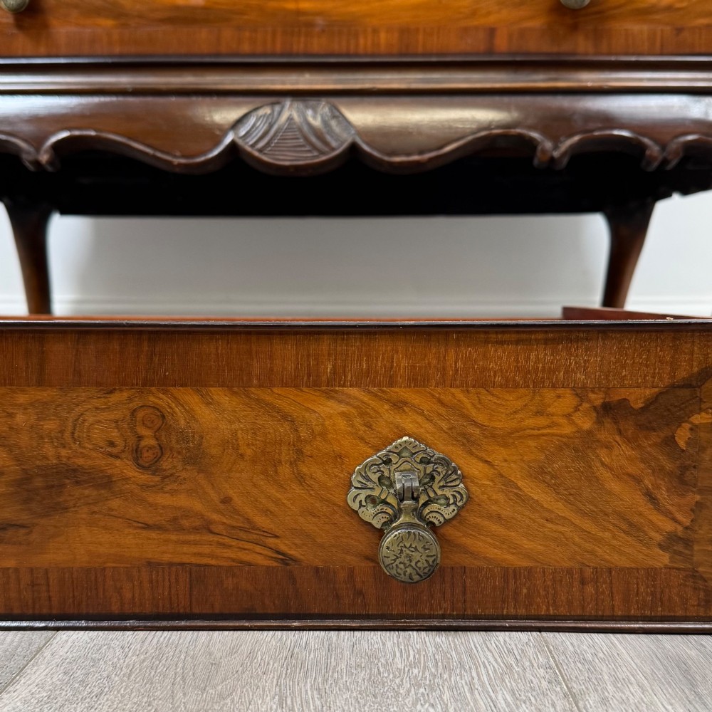 An antique Edwardian figured walnut writing bureau with a slant-front lid, three long drawers, brass handles, and carved cabriole legs on claw-and-ball feet. View XIII