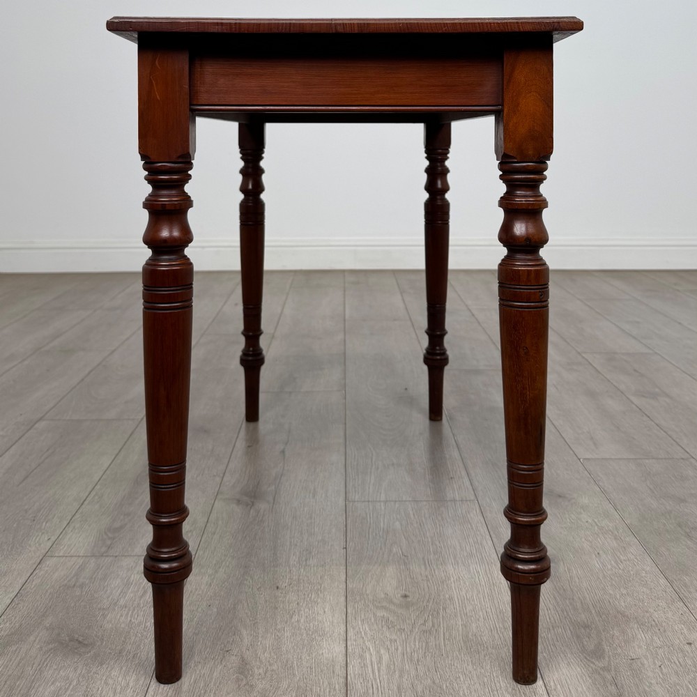An Edwardian walnut side table featuring a plain rectangular top supported by four detailed turned legs. View III