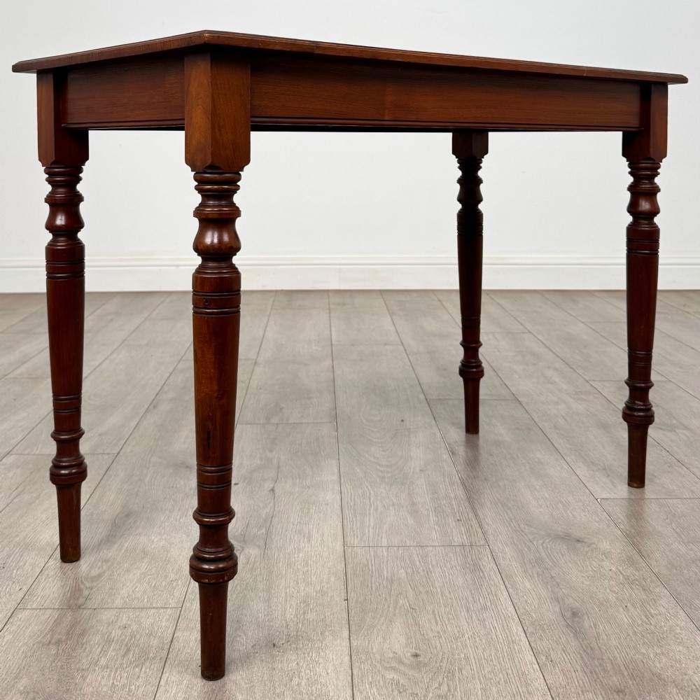 An Edwardian walnut side table featuring a plain rectangular top supported by four detailed turned legs. View IV