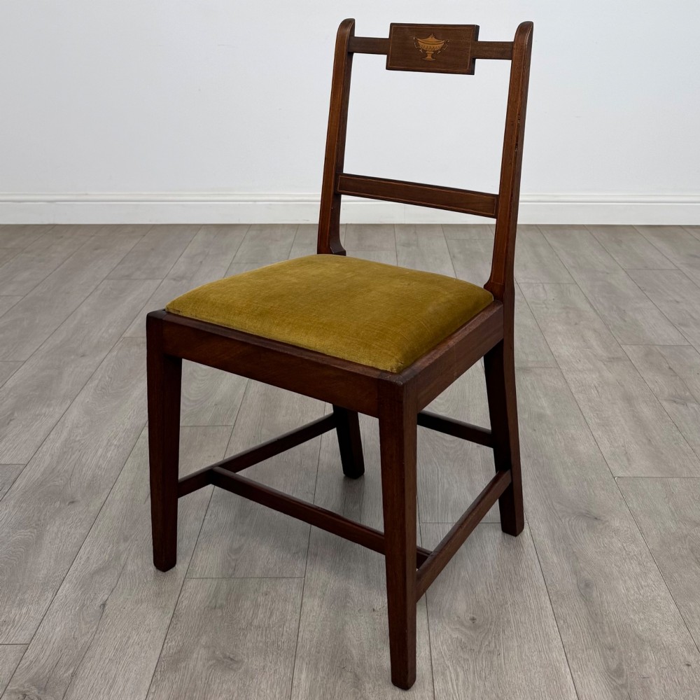 A set of six Georgian mahogany dining chairs featuring open rectangular backs with inlaid urn panels, straight legs with stretchers, and olive green velvet seats. View II