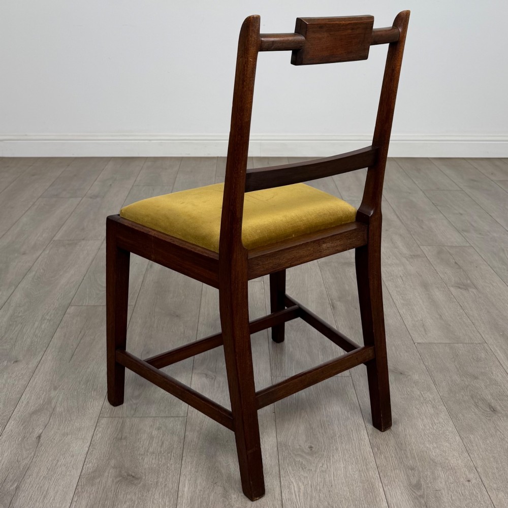 A set of six Georgian mahogany dining chairs featuring open rectangular backs with inlaid urn panels, straight legs with stretchers, and olive green velvet seats. View III