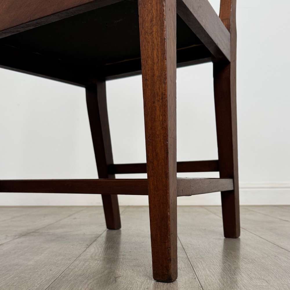 A set of six Georgian mahogany dining chairs featuring open rectangular backs with inlaid urn panels, straight legs with stretchers, and olive green velvet seats. View VI