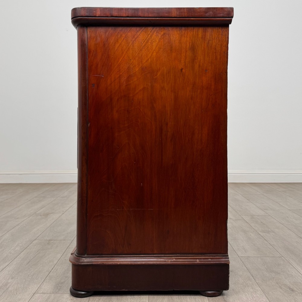 A Victorian dark mahogany chest of drawers featuring two short drawers above two full-width long drawers with turned wooden knobs and a solid plinth base. View III