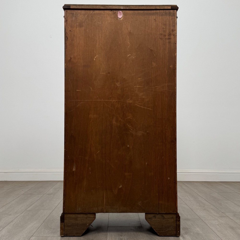 A freestanding burr walnut display cabinet featuring a single glazed door with six glass panes, curved upper frame moulding, and a bracket base. View VI
