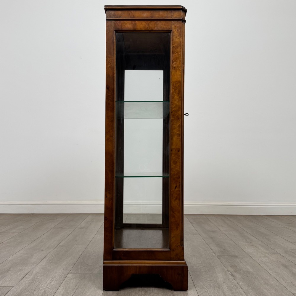 A freestanding burr walnut display cabinet featuring a single glazed door with six glass panes, curved upper frame moulding, and a bracket base. View VIII