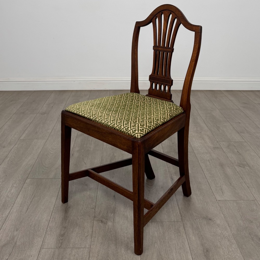 A set of four 18th-century Georgian mahogany dining chairs featuring pierced vertical back splats and green patterned drop-in seats. View II