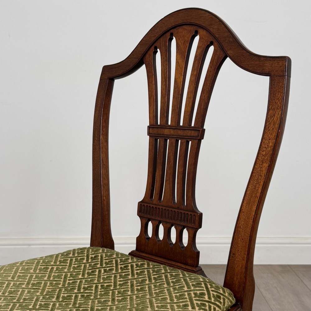 A set of four 18th-century Georgian mahogany dining chairs featuring pierced vertical back splats and green patterned drop-in seats. View IV