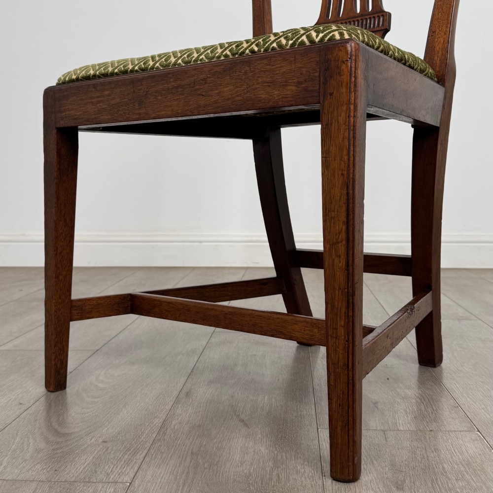 A set of four 18th-century Georgian mahogany dining chairs featuring pierced vertical back splats and green patterned drop-in seats. View V