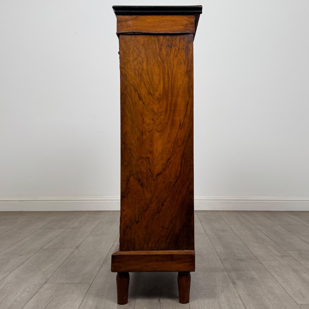 A 19th-century Victorian walnut pier cabinet featuring floral marquetry inlay, gilt brass mounts, and a single glazed door revealing lined interior shelves. View IV
