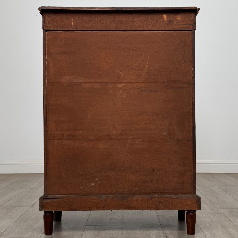 A 19th-century Victorian walnut pier cabinet featuring floral marquetry inlay, gilt brass mounts, and a single glazed door revealing lined interior shelves. View VI