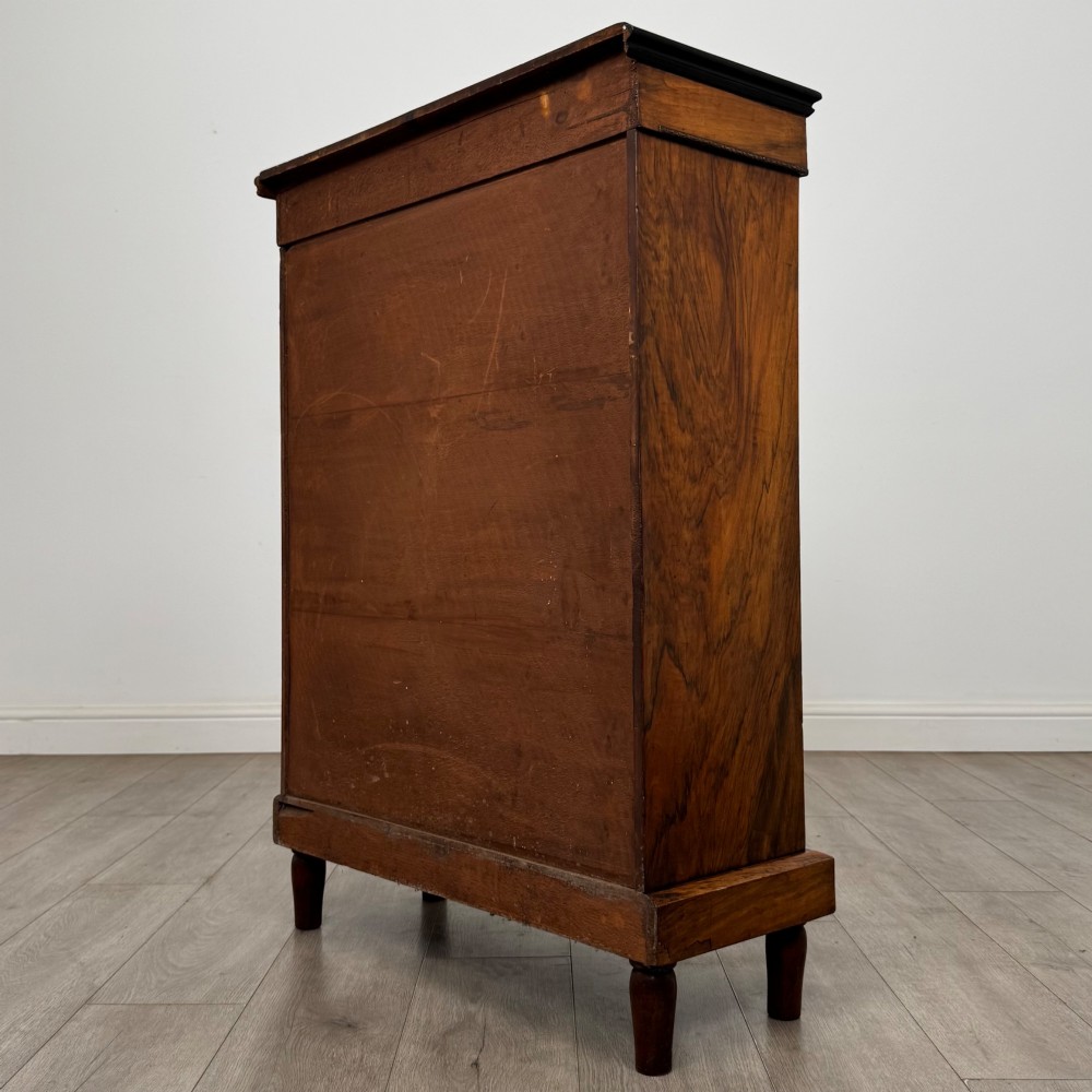 A 19th-century Victorian walnut pier cabinet featuring floral marquetry inlay, gilt brass mounts, and a single glazed door revealing lined interior shelves. View VII