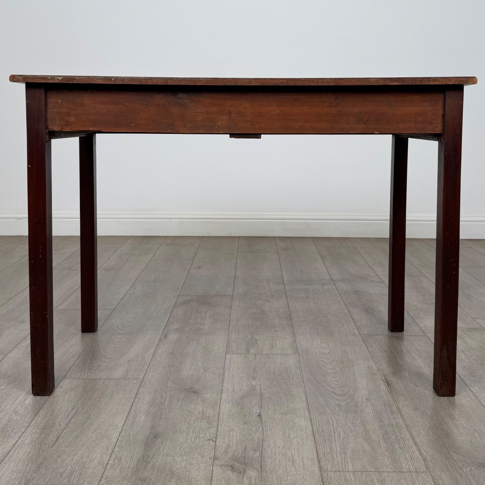 A 19th-century mahogany writing table with a curved serpentine front edge, two drawers with brass handles, and square legs. View V
