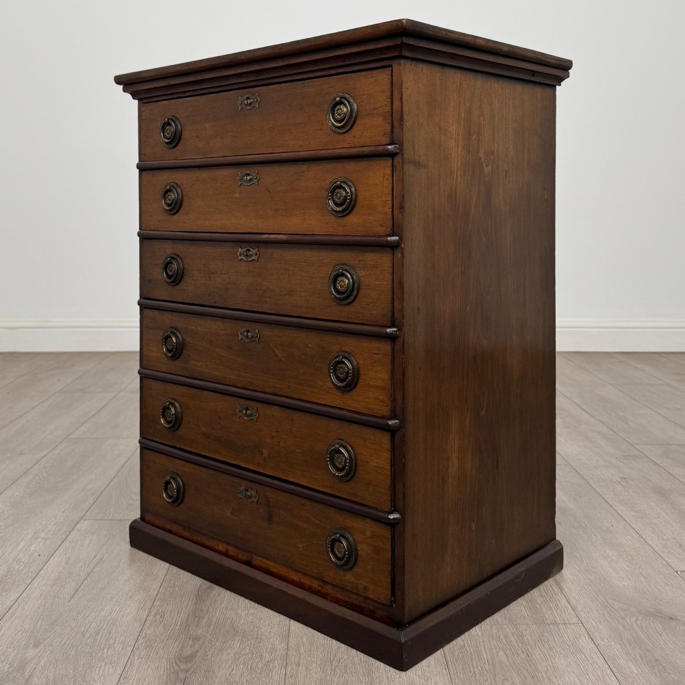 An antique Edwardian mahogany chest of drawers featuring six graduated drawers with round brass ring handles. View II