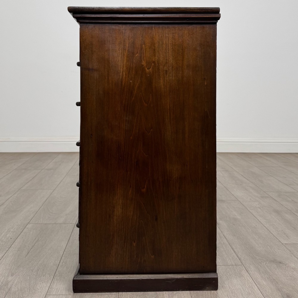 An antique Edwardian mahogany chest of drawers featuring six graduated drawers with round brass ring handles. View III