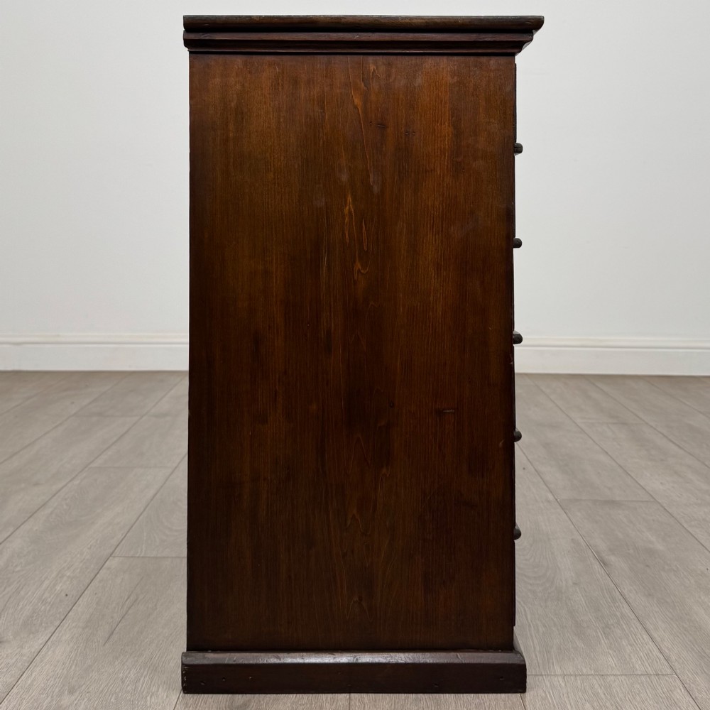 An antique Edwardian mahogany chest of drawers featuring six graduated drawers with round brass ring handles. View VII