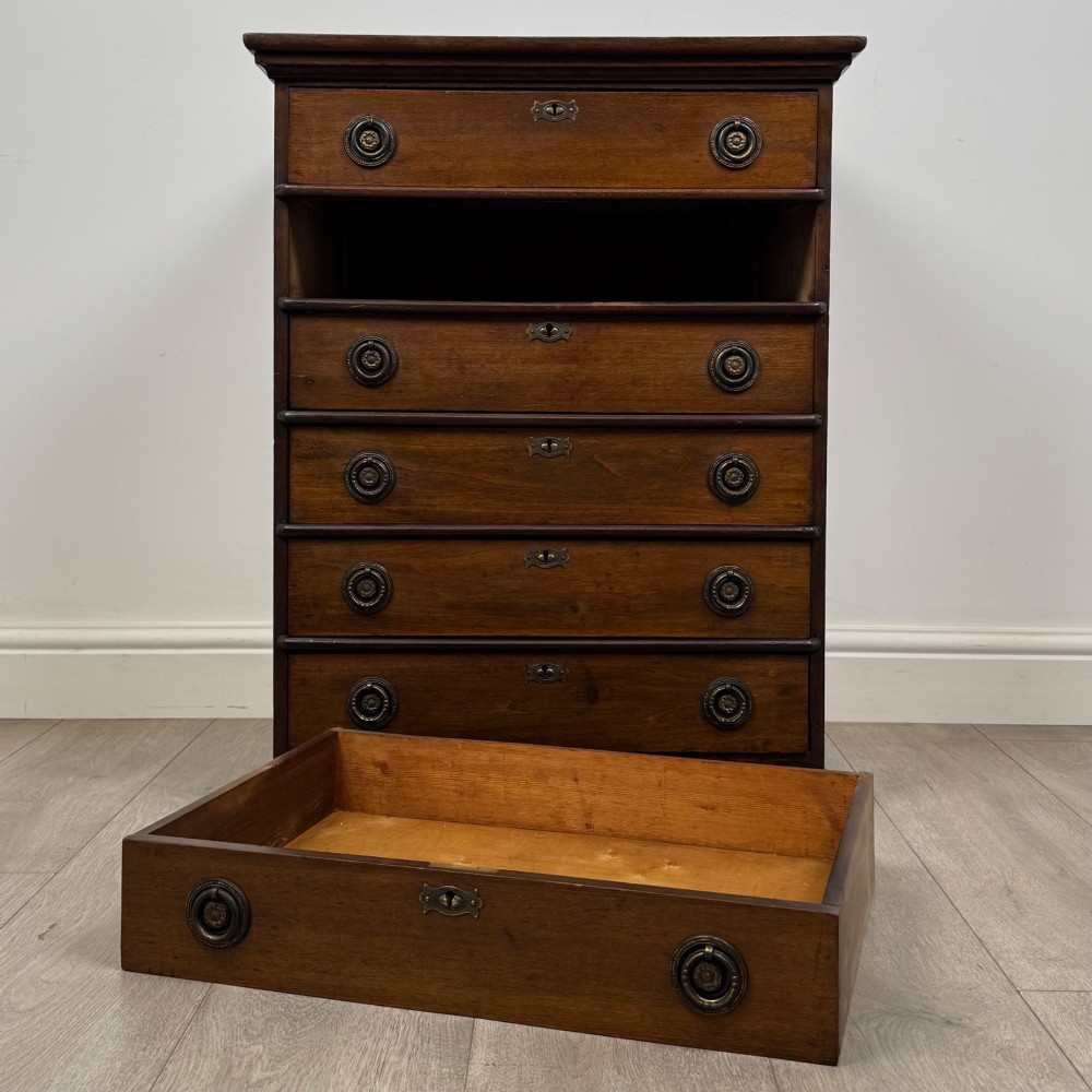 An antique Edwardian mahogany chest of drawers featuring six graduated drawers with round brass ring handles. View X