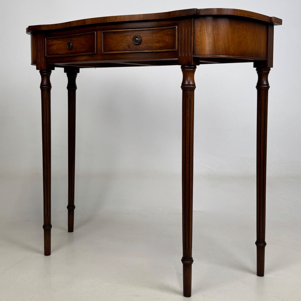 A slender 20th-century mahogany and burr walnut side table featuring two front drawers with brass ring handles and four fluted tapered legs. View II
