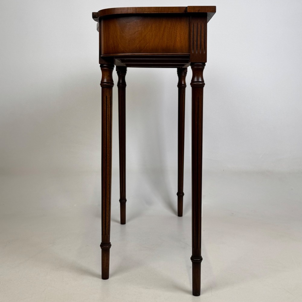 A slender 20th-century mahogany and burr walnut side table featuring two front drawers with brass ring handles and four fluted tapered legs. View III
