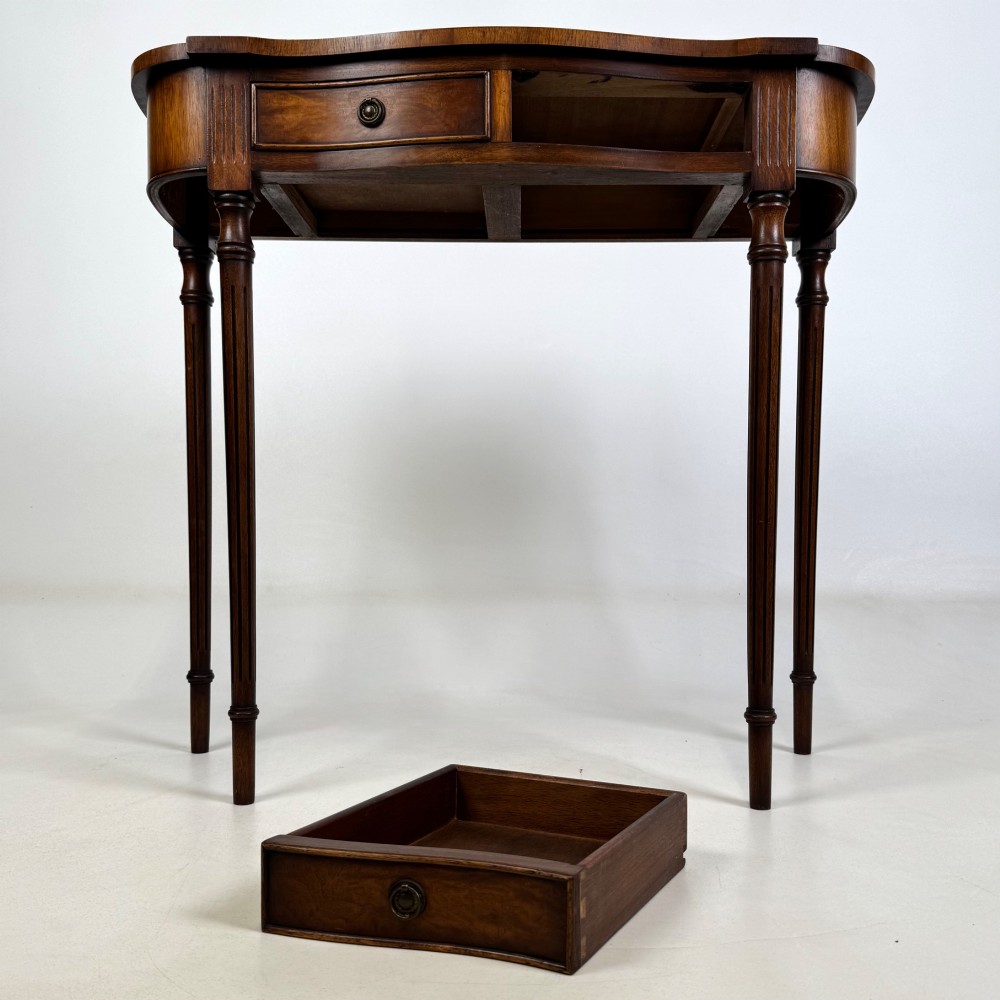 A slender 20th-century mahogany and burr walnut side table featuring two front drawers with brass ring handles and four fluted tapered legs. View IX