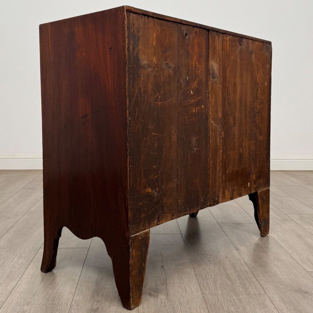 An 18th-century mahogany bow-front chest of drawers featuring three graduated drawers with turned wooden handles and splayed feet. View IV