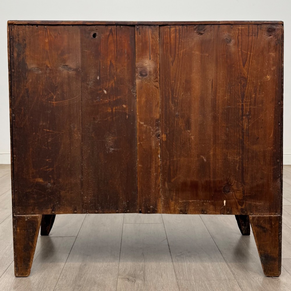An 18th-century mahogany bow-front chest of drawers featuring three graduated drawers with turned wooden handles and splayed feet. View V