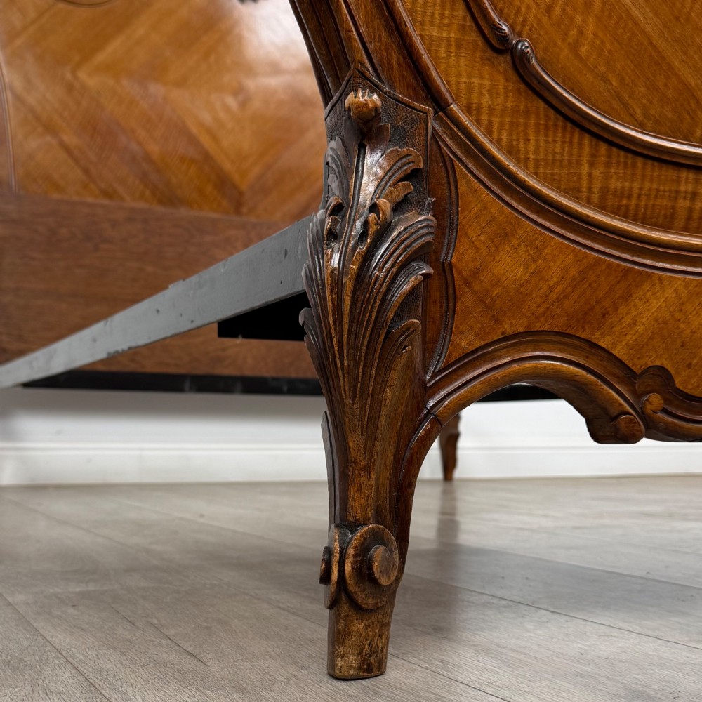 A 19th-century French walnut double bed featuring a carved crest headboard, matching footboard with parquetry panels, and short cabriole legs. View IX