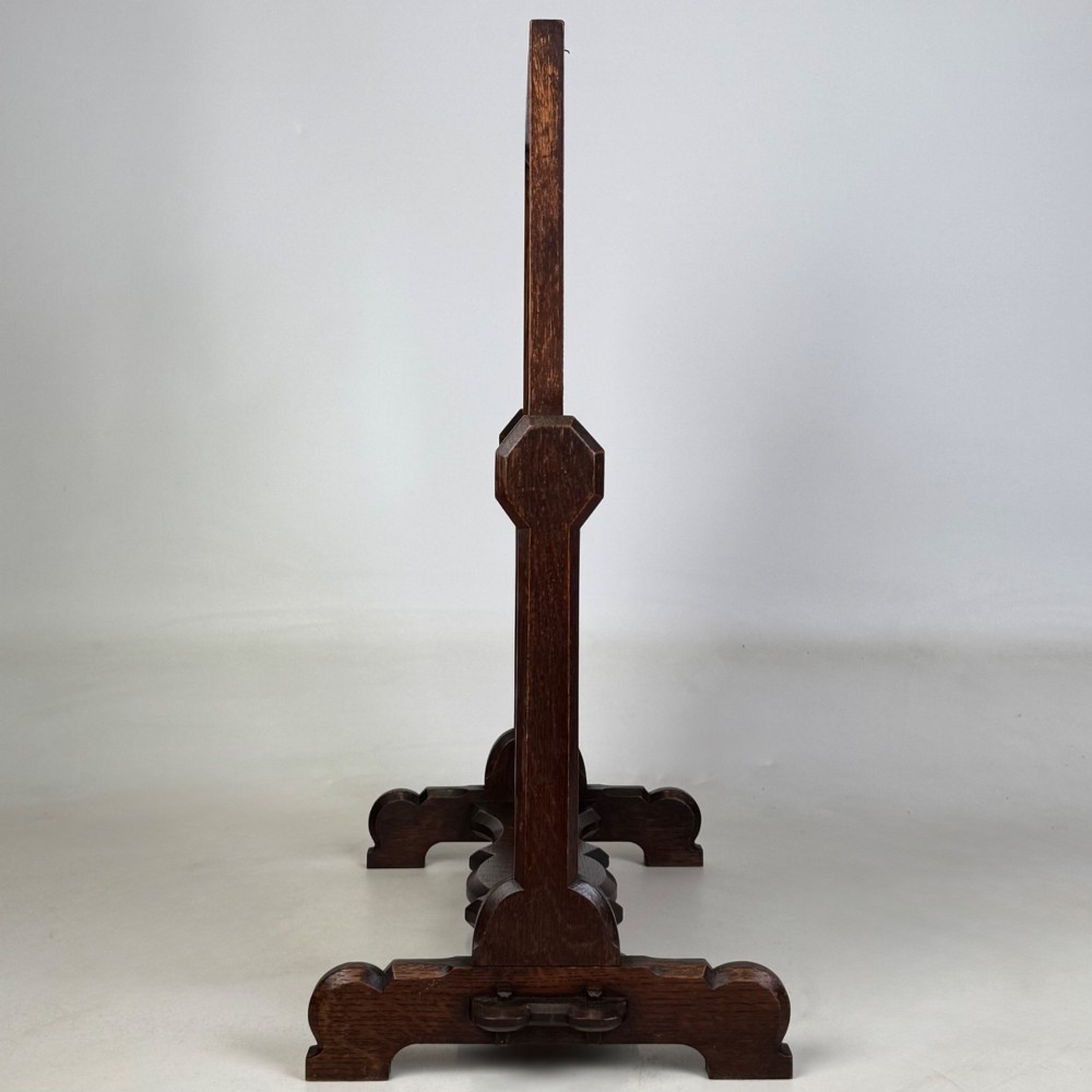 An early 20th-century Arts and Crafts dark oak dressing table mirror set on a shaped base with a swivel frame. View V