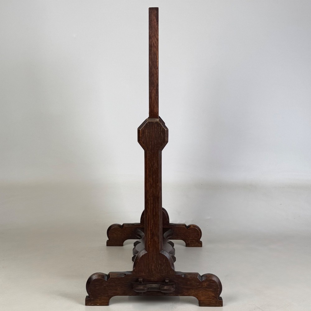 An early 20th-century Arts and Crafts dark oak dressing table mirror set on a shaped base with a swivel frame. View IX