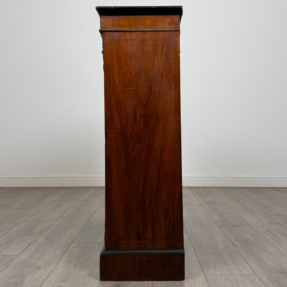 A 19th-century Victorian burr walnut pier cabinet featuring two glass panel doors, brass mounts, marquetry inlay, and a plinth base. View IV