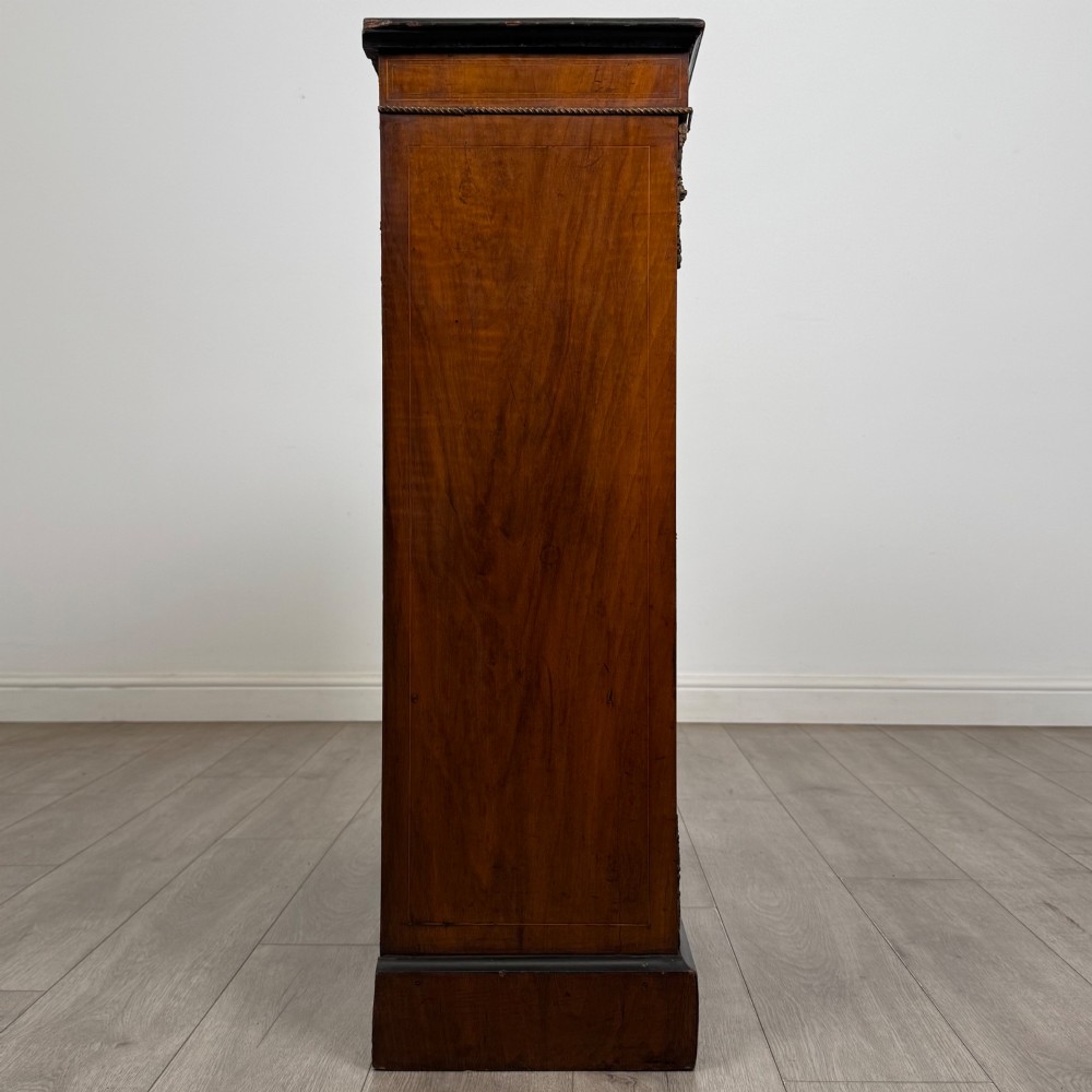 A 19th-century Victorian burr walnut pier cabinet featuring two glass panel doors, brass mounts, marquetry inlay, and a plinth base. View VIII