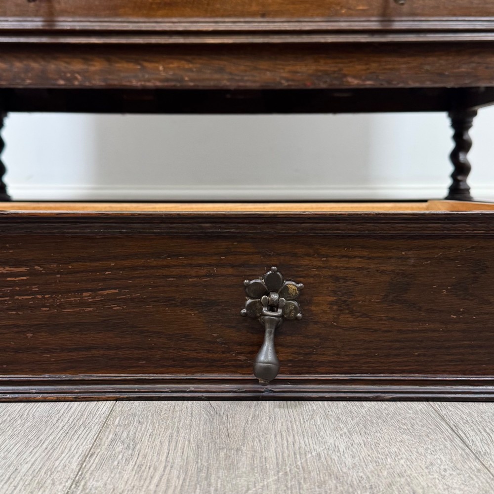 A tall 20th-century Jacobean Revival dark oak bureau bookcase with a leaded glass cabinet above a slant-front writing desk and three lower drawers. View XIV