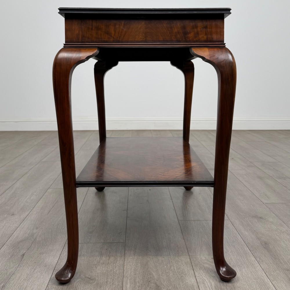An Edwardian burr walnut side table featuring sloped cabriole legs, pad feet, a deep frieze, and a lower undertier shelf. View III