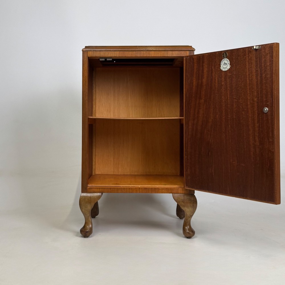 A pair of warm brown walnut bedside cabinets featuring single door cupboards, small round knobs, and carved cabriole legs with pad feet. View III