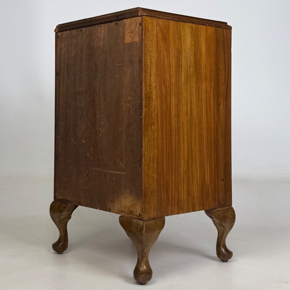 A pair of warm brown walnut bedside cabinets featuring single door cupboards, small round knobs, and carved cabriole legs with pad feet. View VIII