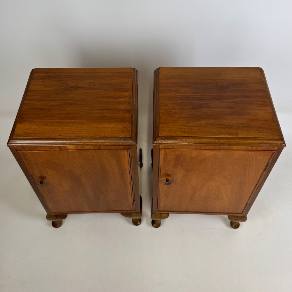 A pair of warm brown walnut bedside cabinets featuring single door cupboards, small round knobs, and carved cabriole legs with pad feet. View XI