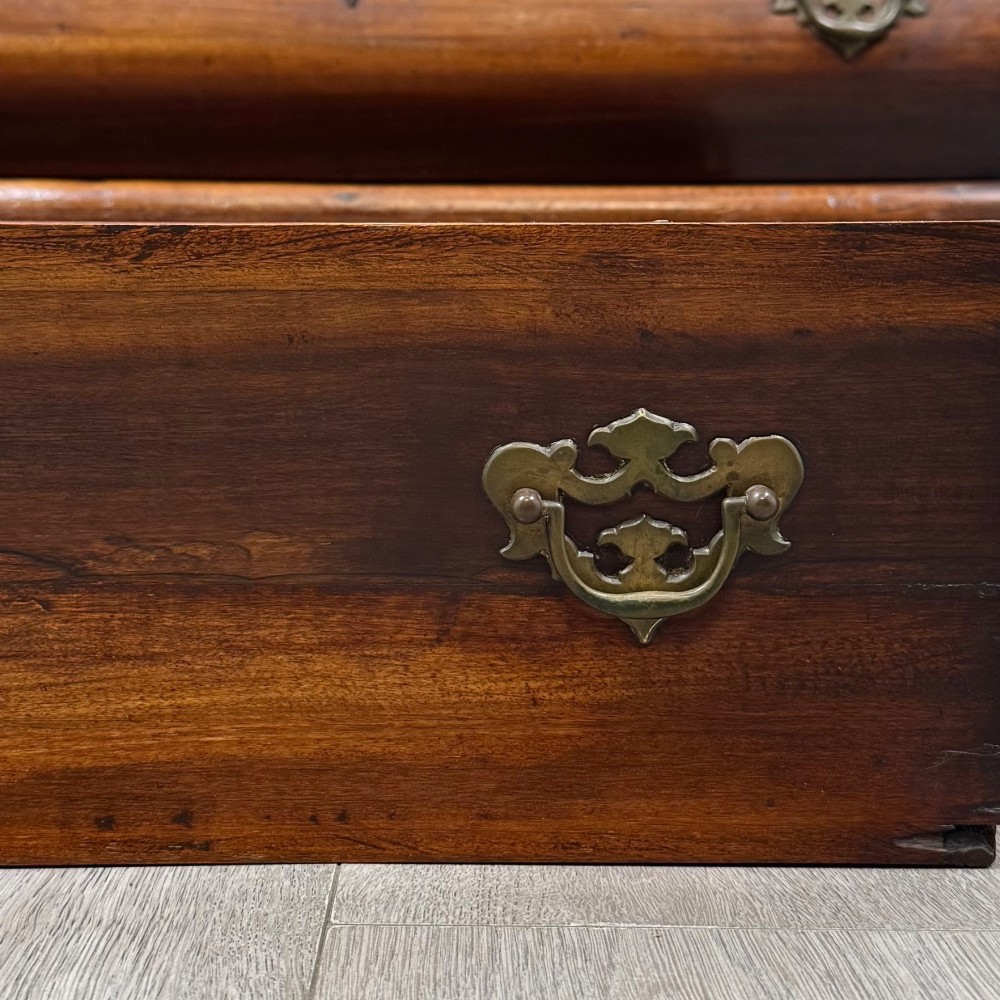 A small 20th-century Dutch bombe chest of drawers made from polished brown wood with three drawers, brass handles, and carved claw feet. View XI