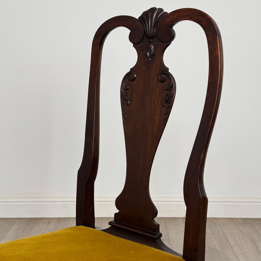 A set of six dark mahogany dining chairs featuring cabriole legs, carved back splats, and gold velvet drop-in seats. View V