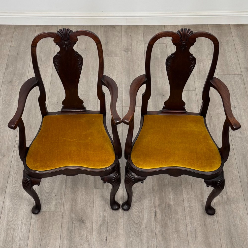 A set of six dark mahogany dining chairs featuring cabriole legs, carved back splats, and gold velvet drop-in seats. View VIII
