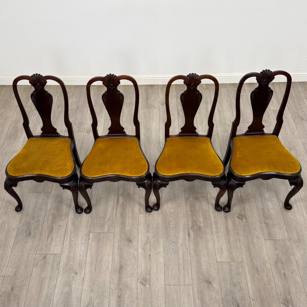 A set of six dark mahogany dining chairs featuring cabriole legs, carved back splats, and gold velvet drop-in seats. View IX