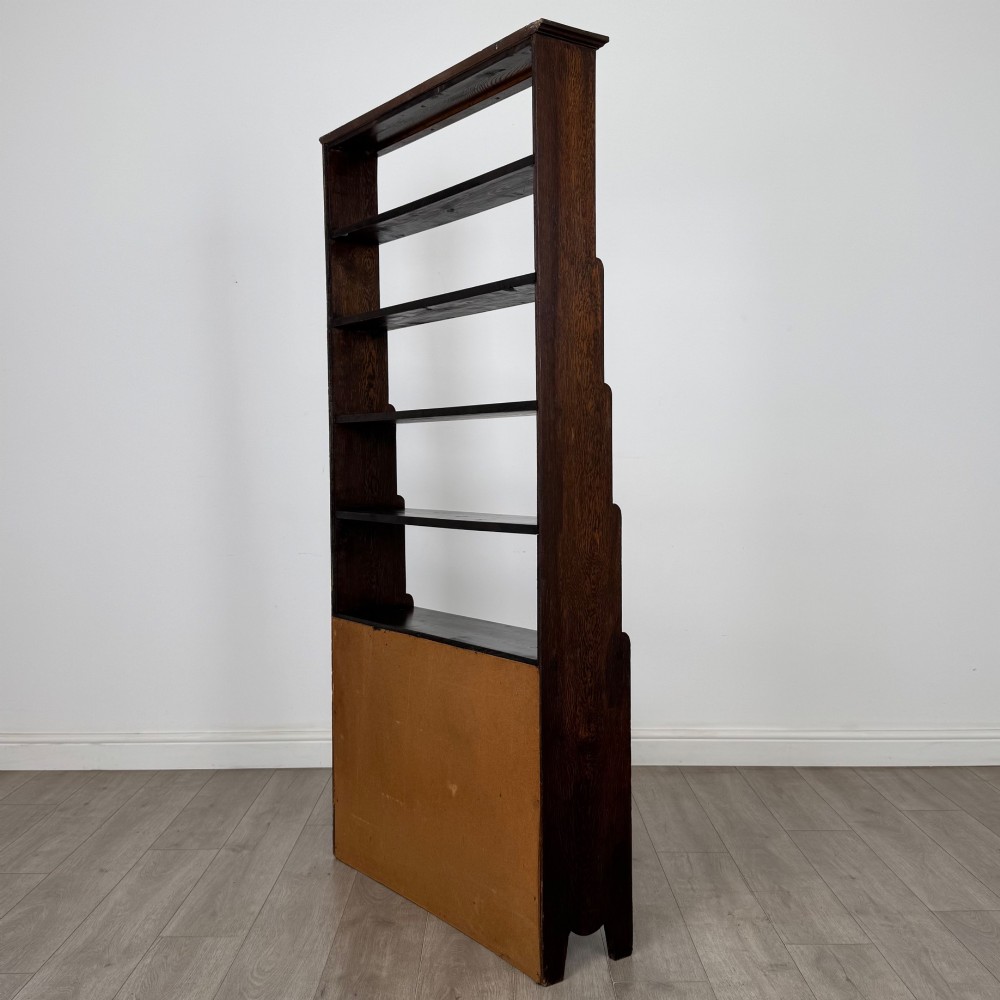 A tall dark oak open bookcase featuring multiple upper shelves and a two-door lower cupboard base. View VIII