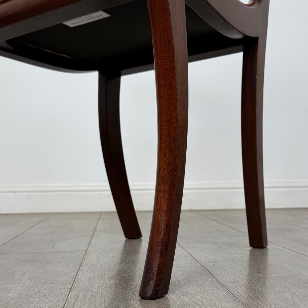 A set of ten mahogany Regency style dining chairs with yellow upholstered seats, including eight side chairs and two carvers with scrolling arms. View IX