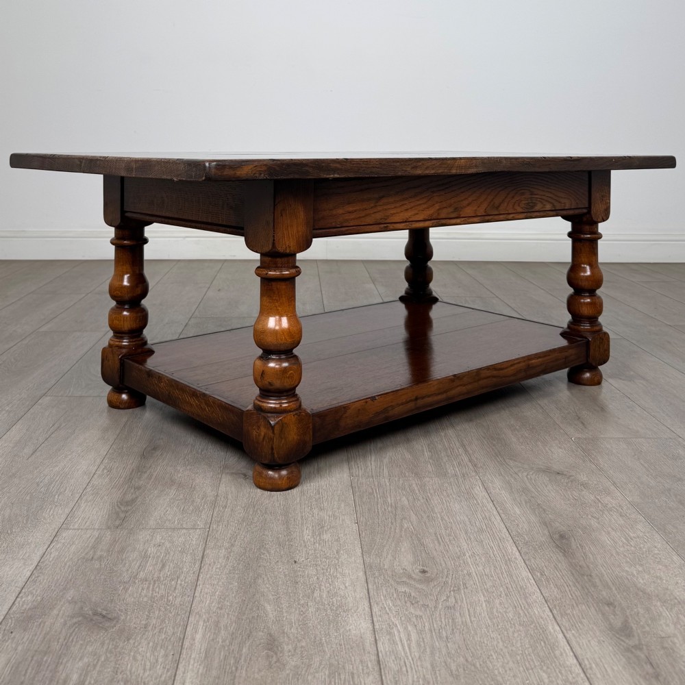 A rectangular dark oak coffee table featuring turned baluster legs and a full-length lower shelf. View IV
