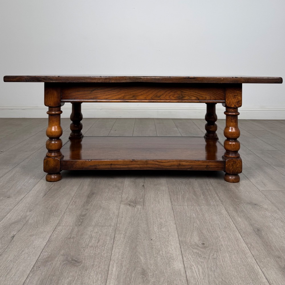 A rectangular dark oak coffee table featuring turned baluster legs and a full-length lower shelf. View V